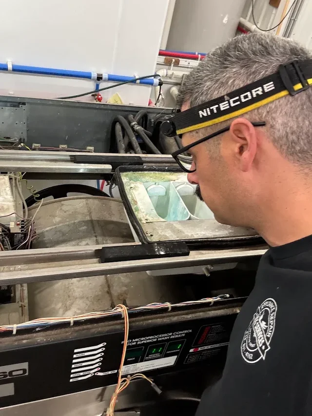Technician working on an open washing machine