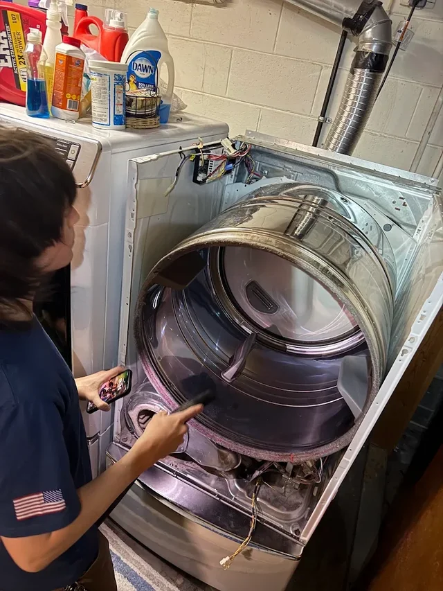 Technician diagnosing a washing machine