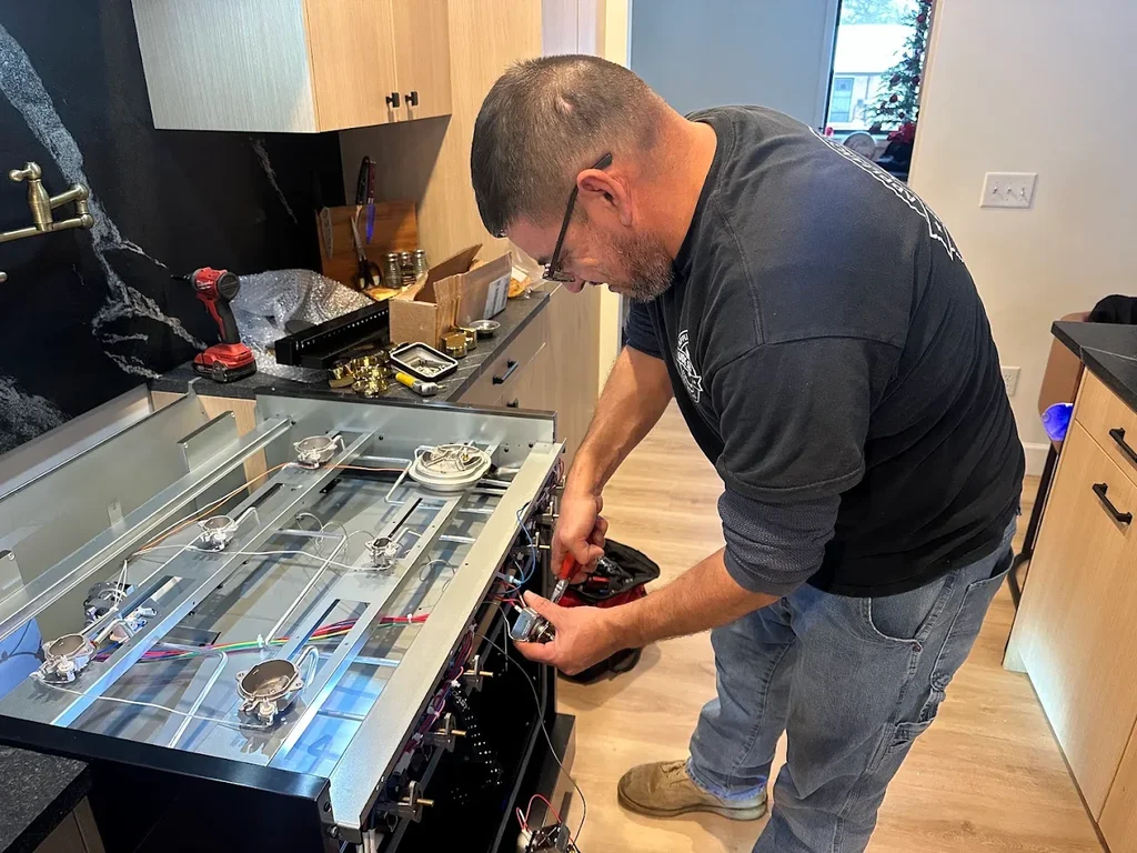 Technician repairing a gas range